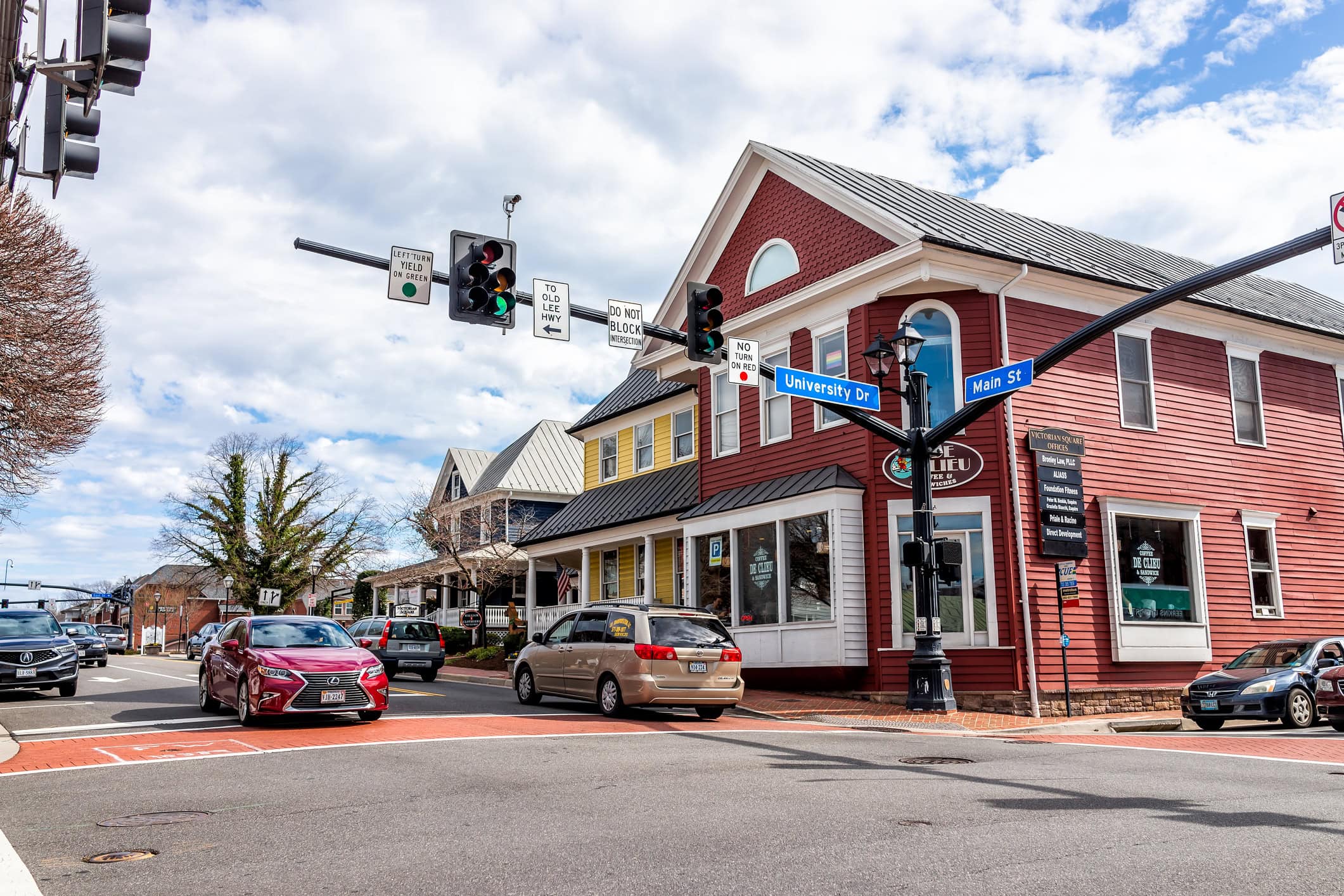 City of Fairfax, USA - March 10, 2020: Downtown old town at University drive, Main street intersection with stores, shops and restaurants in Fairfax county with office buildings in Northern Virginia