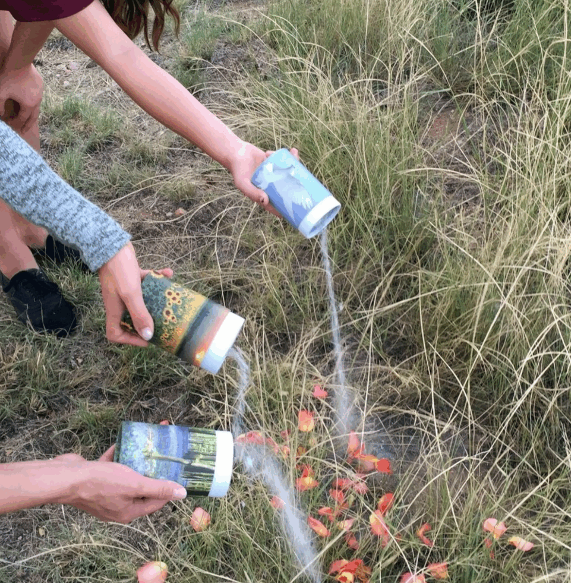 3 people with tiny scatter urn scattering ashes out