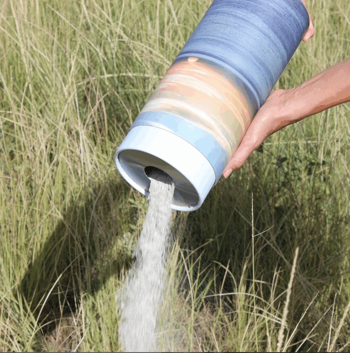Paper Sunset Scatter Urn with ashes pouring out